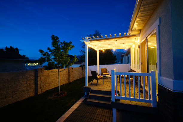 a backyard of a suburban usa home with a deck and pergola.