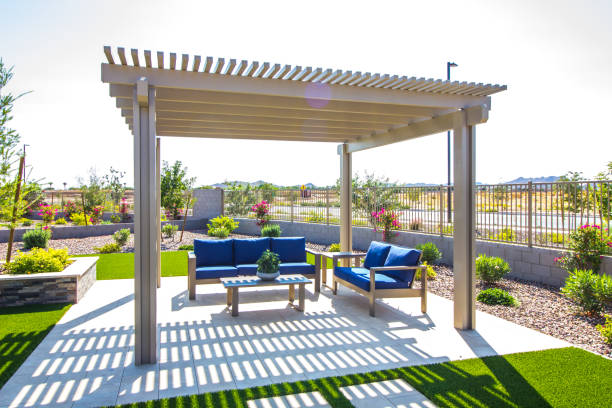 back yard pergola covering blue cushion patio furniture