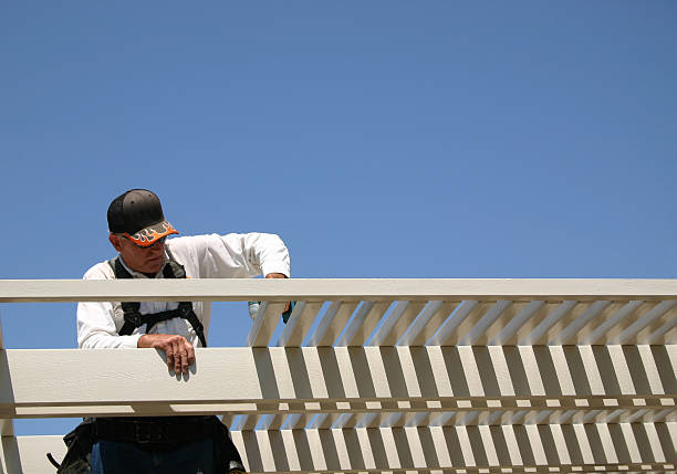 man building aluminum patio awning.