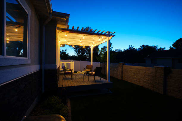 a backyard of a suburban usa home with a deck and pergola.