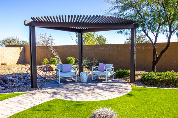 back yard pergola with two arm chairs on pavers