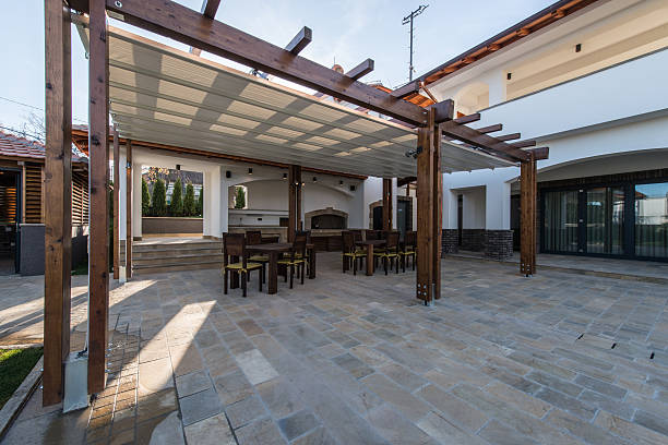 beautiful terrace lounge with pergola and wooden table with chairs